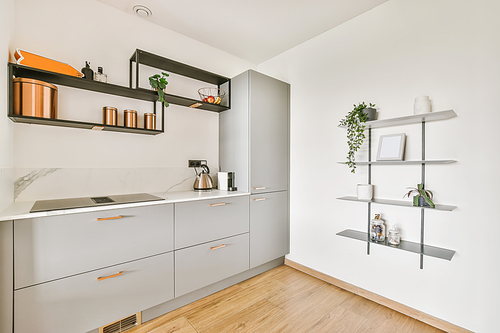 Stunning kitchen with gray kitchen unit and wall shelves