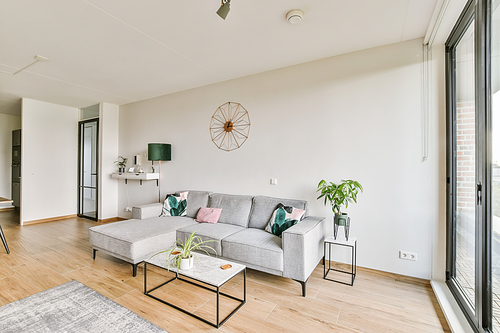 Stunning living area with gray plush sofa and glass coffee table