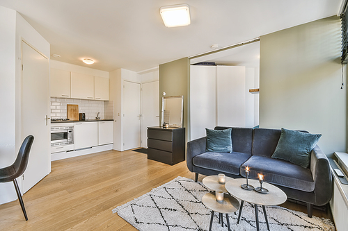 Delightful living room with black comfortable sofa with round coffee table