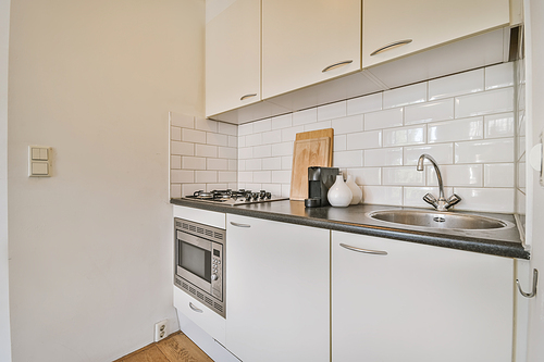 Delightful small kitchen area with microwave built into the kitchen unit