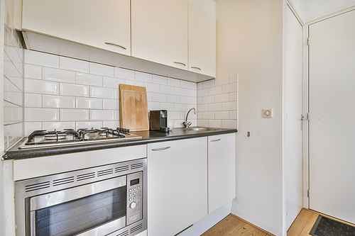Delightful small kitchen area with microwave built into the kitchen unit