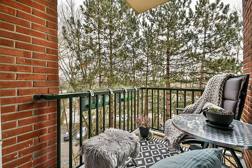 Cozy balcony with a seating area for relaxation and an iron fence