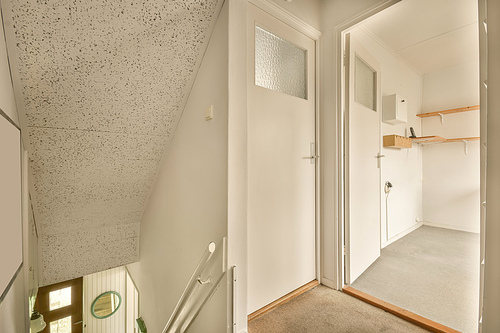 Stairs leading to the upper floor in white in a modern house