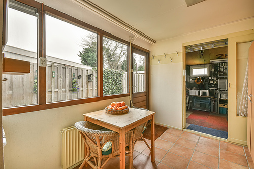 A small sitting area with wicker furniture by the window in a modern house