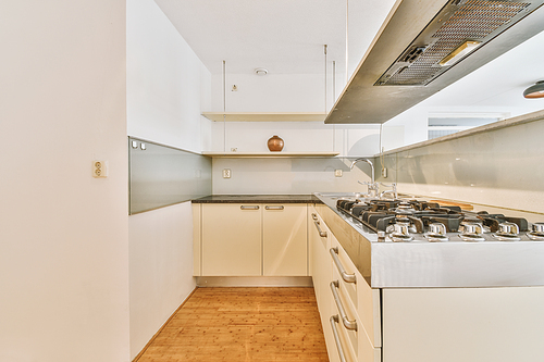 Minimalist kitchen interior with white decoration and modern appliances in a cozy house