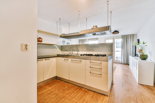 Minimalist kitchen interior with white decoration and modern appliances in a cozy house