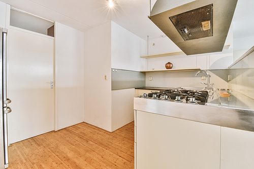 Minimalist kitchen interior with white decoration and modern appliances in a cozy house