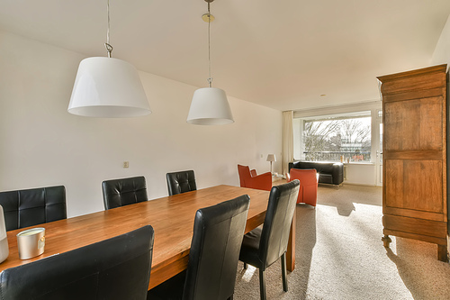 Large dining area for with access to the living room in an open-style apartment