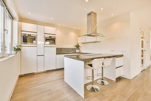 View of bright kitchen with window and white wall