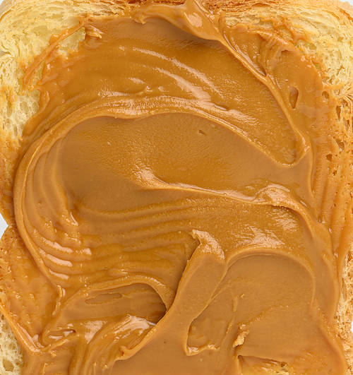 texture of peanut butter spread on bread, full frame