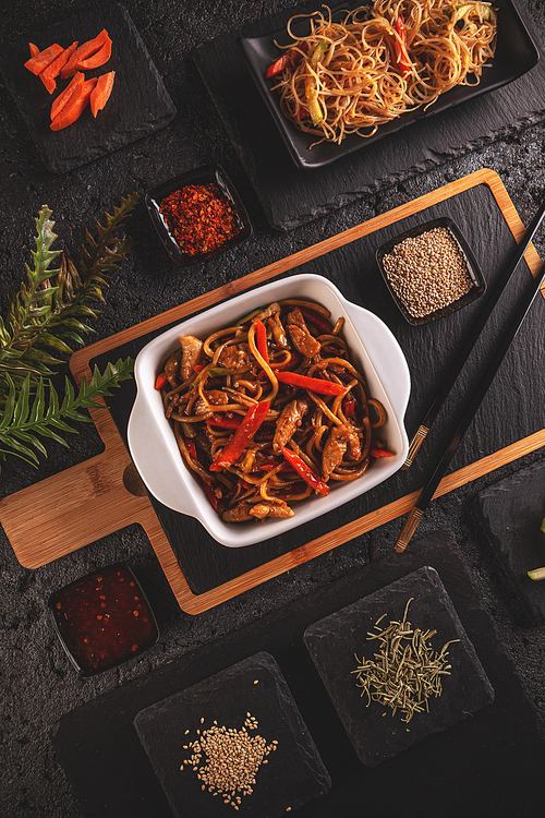 Typical Chinese dish, fresh chicken stir fried with vegetables served with pasta