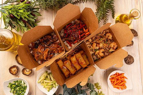 Flat lay of Chinese takeaway food packaged in special boxe