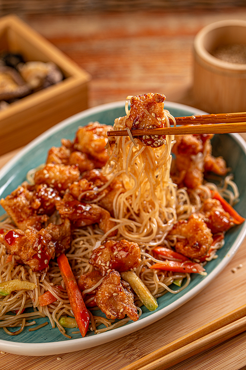 Spicy stir fried chicken on chopsticks, Chinese food