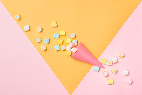 Minimal flat lay. Top view of the pastel marshmallows on a pinkbackground.