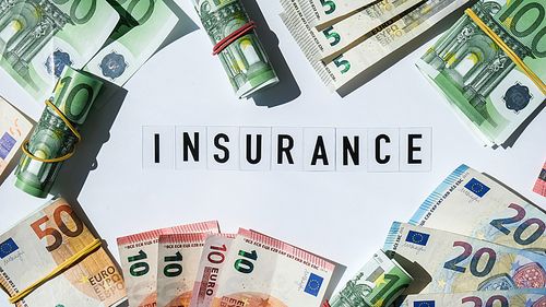 Text INSURANCE around Euro banknotes. Health, life, home, car Insurance. Insurance business concept. Business budget of wealth and prosperity finance. Health care or medicare insurance and vaccination costs. Financial crisis. Covid-19 crimes