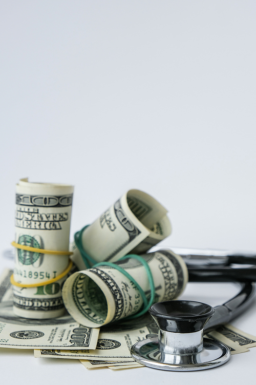 Stack of cash dollars and stethoscope. The concept of medical expensive medicine, doctors salary. Copy space for text. Health Life insurance. vaccination costs. Financial crisis. Covid-19 crimes