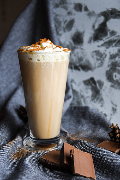 iced coffee with cream on rustic table, Coffee drink in a transparent mug with chocolate, hot winter drink, christmas drinks