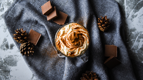 iced coffee with cream on rustic table, Coffee drink in a transparent mug with chocolate, hot winter drink, christmas drinks