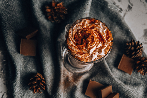 Glass of Latte Macchiato, Delicious hot chocolate, Cup of coffee with cinnamon, chocolate and cream, Cup of hot cappuccino with cinnamon for breakfast