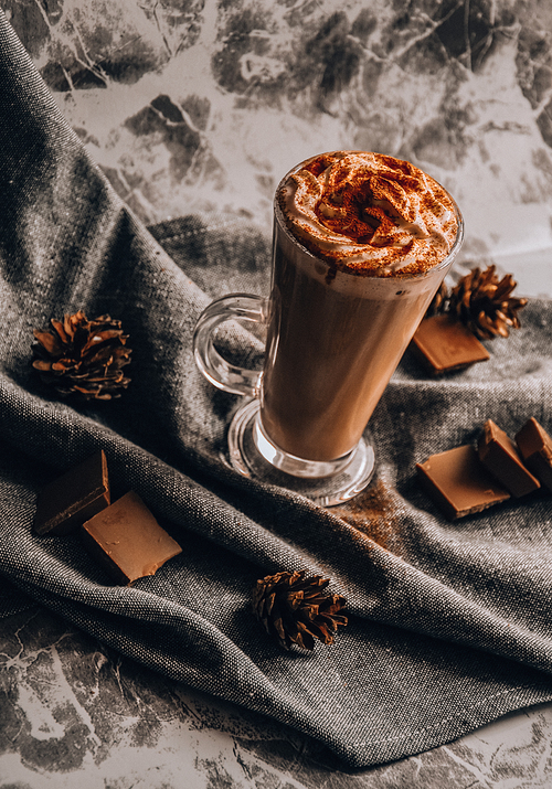 Glass of Latte Macchiato, Delicious hot chocolate, Cup of coffee with cinnamon, chocolate and cream, Cup of hot cappuccino with cinnamon for breakfast