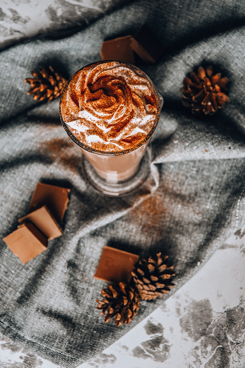 iced coffee with cream on rustic table, Coffee drink in a transparent mug with chocolate, hot winter drink, christmas drinks