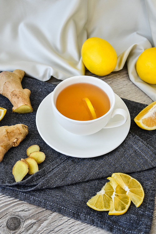 Ginger hot immunity boosting Vitamin natural drink With citrus lemon cinnamon anise in a rustic style on wooden background. Chamomile tea. Healthy concept