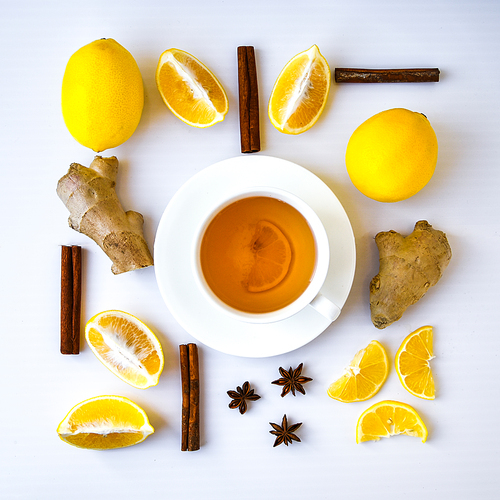 Trendy flat lay Ginger hot immunity boosting Vitamin natural drink With citrus lemon cinnamon anise in a rustic style on white background. Chamomile tea. Healthy concept