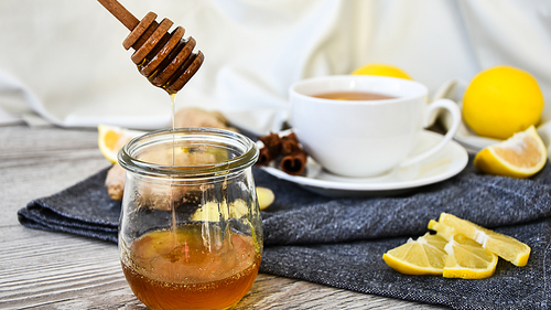 Ginger hot immunity boosting Vitamin natural drink With citrus, honey and ingredients in a rustic style on wooden background. Chamomile tea. Healthy concept