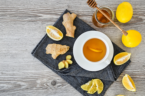 Ginger hot immunity boosting Vitamin natural drink With citrus, honey and ingredients in a rustic style on wooden background. Chamomile tea. Healthy concept