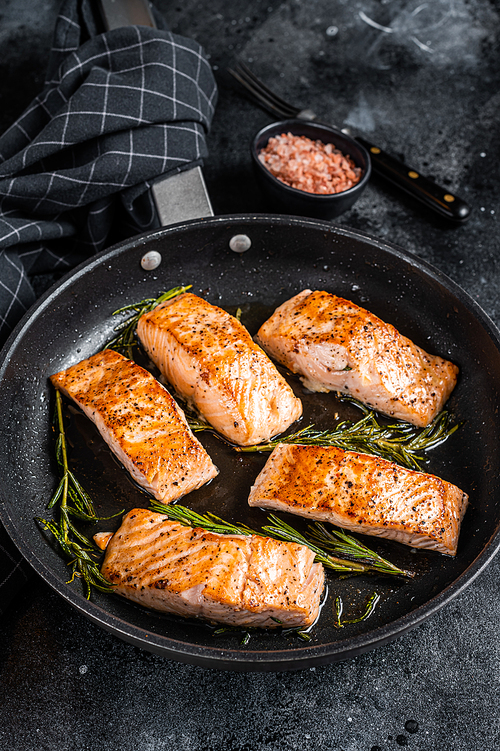 Grilled Salmon Fillet Steak in a pan. Black background. Top view.