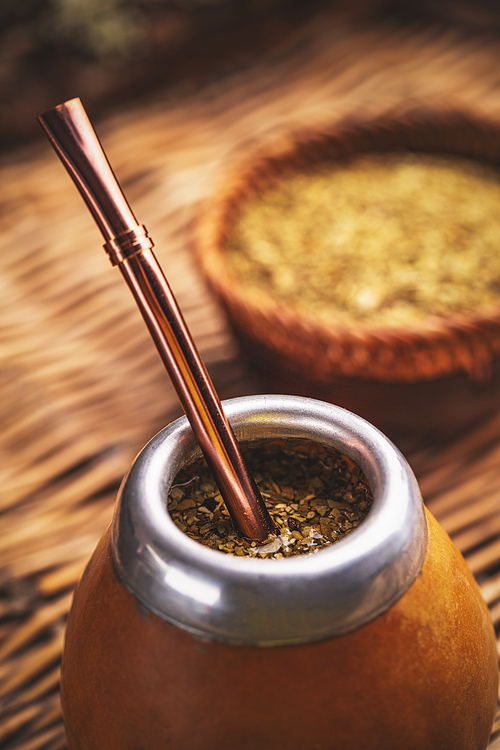 Close up of yerba mate tea in a calabash gourd with bombilla
