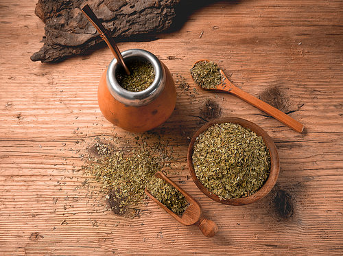 Flat lay of traditional South American yerba mate tea served in the calabash gourd with bombilla