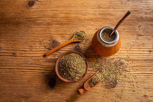 Traditional South American yerba mate leaves and tea served in the calabash with bombilla