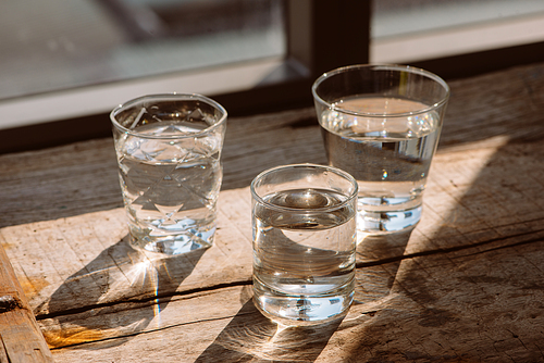 Drink a glass of water on a wooden floor.