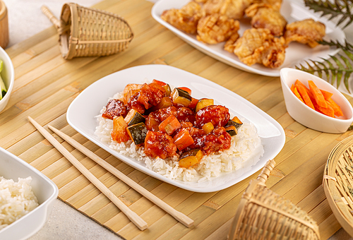 Sweet and sour chicken with rice on a plate