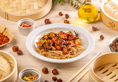 Stir-fried noodles dish with pork and vegetables. Traditional Chinese chow mein