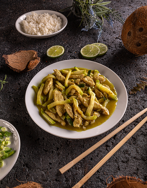 Asian stir fry dish, chicken with zucchini prepared with cocos milk