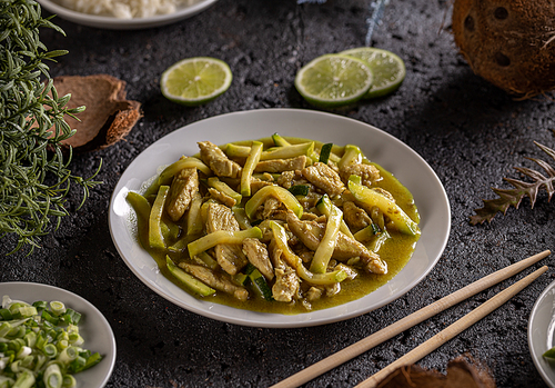 Stir fry chicken and zucchini prepared with cocos milk, Asian style cuisine