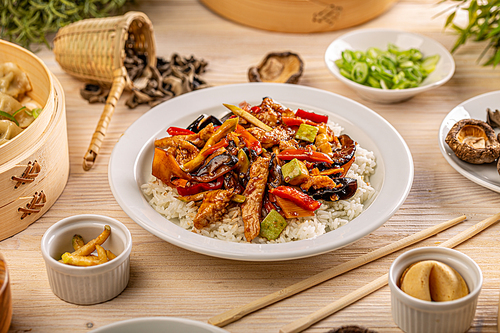 Slices of chicken with jelly ear and vegetables in spicy sauce served with rice, Chinese main course