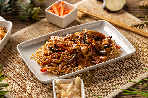 Chinese deep fried noodle with bamboo shoots served on white plate