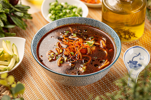 Asian style soup with vegetables in a bowl on the table