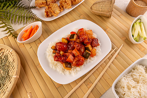 Chicken on sweet and sour sauce served with boiled rice