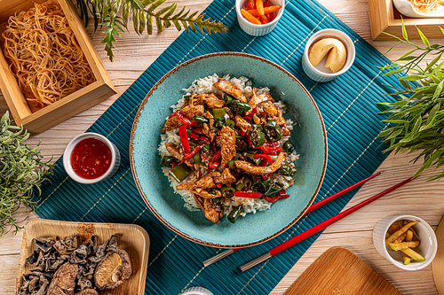 Top view of Asian style chicken with rice, chili and jalapeno pepper