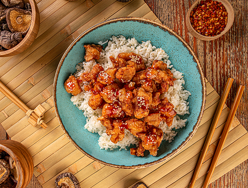 Teriyaki chicken with rice, served with sesame seeds, top view