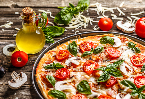 Fresh pizza with tomatoes, cheese and mushrooms on wooden table closeup