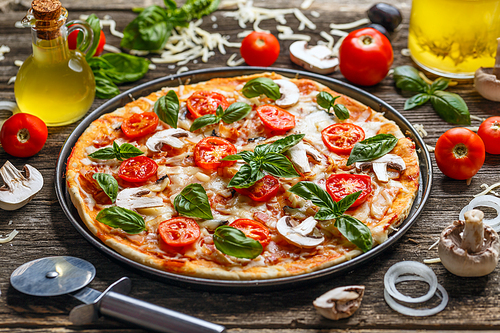 Delicious Italian pizza on wooden background