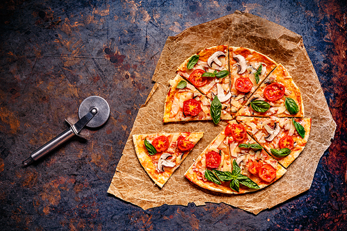 Top view of fresh baked pizza, pizza slice served on vintage background