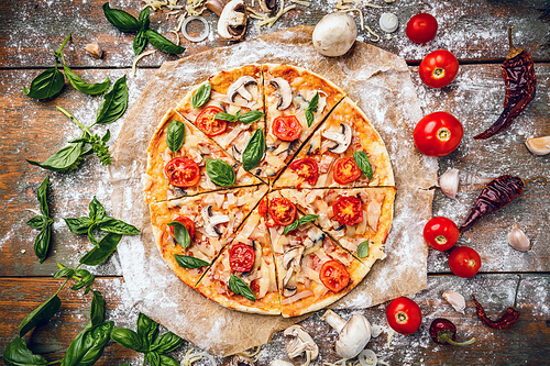 Flat lay of Italian pizza on wooden background and various ingredients