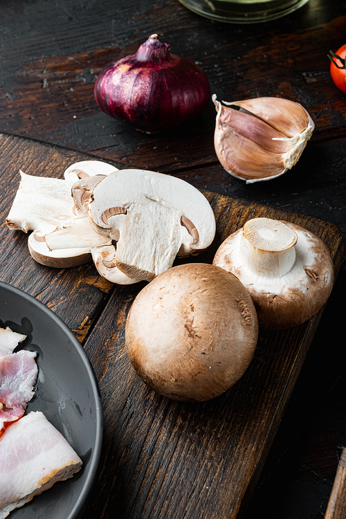 Raw mushrooms champignons set, on old dark  wooden table background