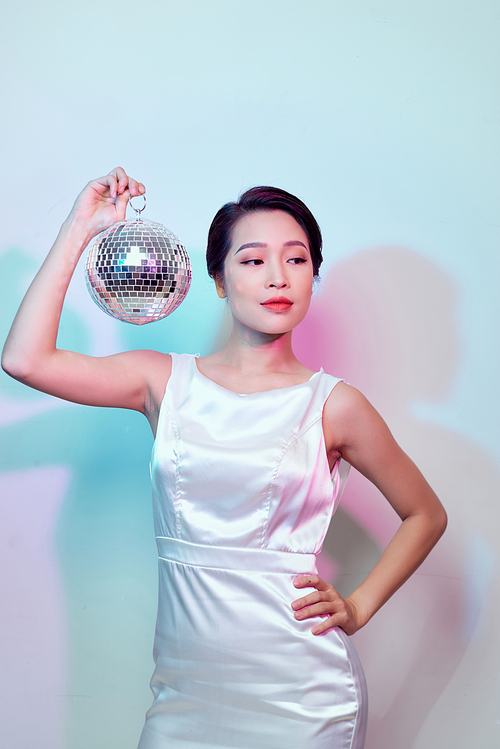 stylish young woman with a mirror ball